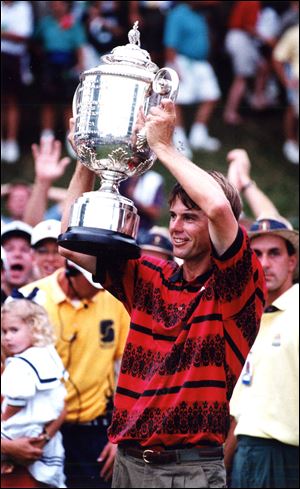 Paul Azinger hoists the Wanamaker Trophy at the 1993 PGA Championship at Inverness after defeating Greg Norman in a two-hole sudden-death playoff.
