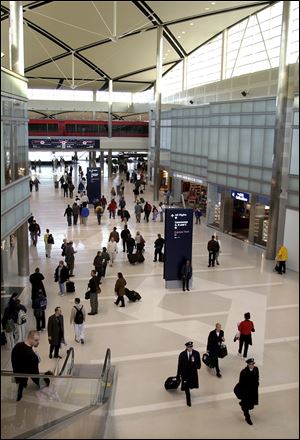 Passengers and flight crews walk through the Edward H. McNamara Terminal at Detroit Metro Airport.