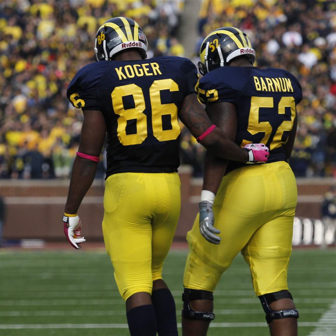 Michigan-s-Kevin-Koger-helps-teammate-Ricky-Barnum