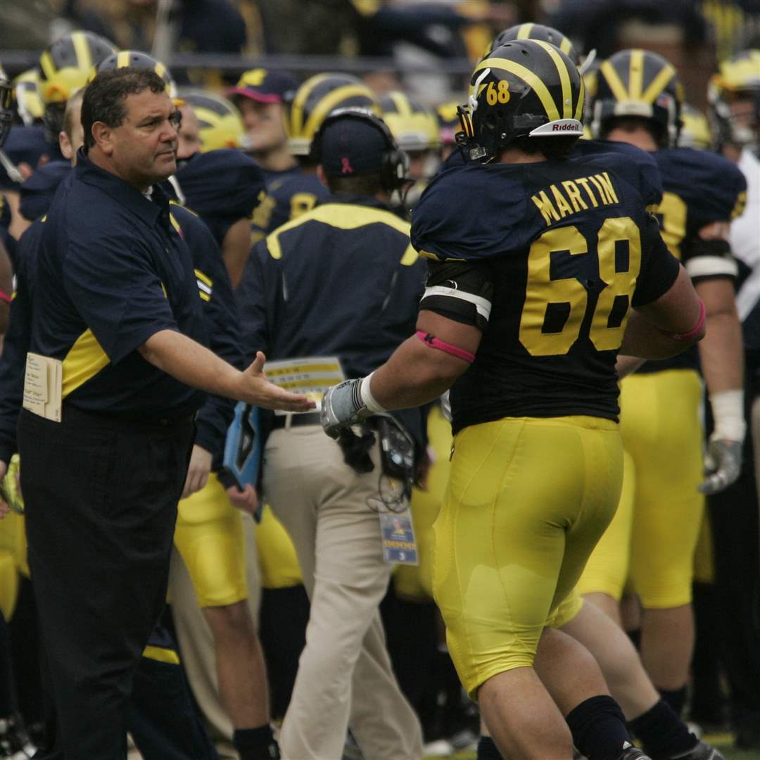 UM-s-Brady-Hoke-shakes-shakes-hands-with-Mike-Martin-after-he-forced-a-Purdue-safety