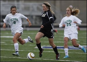 Perrysburg's Maddy Williams moves the ball against Medina during her high school career as a Yellow Jacket. Williams scored a program-record 48 goals for the 2012 state champions.