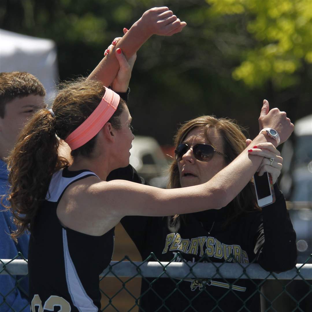The-arms-of-Perrysburg-runner-Courtney-Clody-is-held-up-by-her