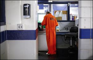 An inmate is finger printed at the Lucas County Jail.