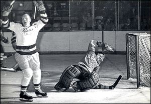 Chick Chalmers of the Toledo Blades scores a playoff goal against Fort Wayne goalie Chuck Adamson in 1964. The Blades won the IHL championship over the Komets that season.