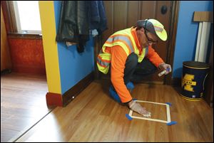 Anthony Weaver, a lead-clearance technician, uses a dust wipe to check for lead in a home. Many inspectors and landlords hesitate to set up inspections because of looming changes.