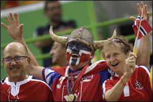Norwegian fans wait for the beginning of the women's semifinal handball match between Norway and Russia at the 2016 Summer Olympics in Rio de Janeiro, Brazil. A global happiness report indicates that Norway tops the world happiness rankings, edging out Denmark which was No.1 in the previous report.
