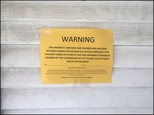 A placards like this one on an East Toledo home posted by Toledo-Lucas County Health Department after the Ohio Department of Health released a list of properties in the state with orders to vacate due to untreated lead hazards. 