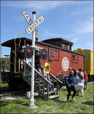 Students tour the Nickel Plate Road car at the Wolcott Heritage Center & Grounds in Maumee.