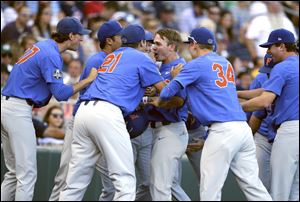 Florida's Deacon Liput, center, is mobbed by teammates after a home run in the 2017 College World Series. The Gators are ranked No. 1, and SEC teams line the top of the polls.