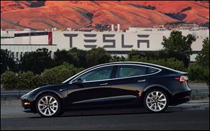 Tesla is raising $1.5 billion as it ramps up production of its Model 3 sedan, its first mass market electric car, the company said Aug. 7.