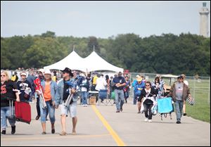 Fans enter during the Bash On The Bay country music festival at Put-in-Bay, Ohio, on Thursday. Toby Keith headlines the event.