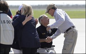 Texas Gov. Greg Abbott, center, greets Energy Secretary Rick Perry, right, as they prepare to visit areas affected by Hurricane Harvey on Thursday in Corpus Christi, Texas.