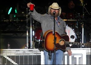 Toby Keith raises his cup as he performs during the Bash On The Bay country music festival at Put-in-Bay, Ohio.