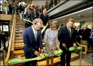 ProMedica CEO and President Randy Oostra, left, Pro Medica Senior Vice-President Real Estate and Construction Robin Whitney,  and Bob LaClair, CEO and President of Fifth Third Bank, among others, cut the ribbon during the opening of the new ProMedica headquarters in downtown Toledo.
