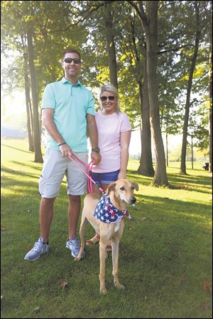 Sgt. Sean McGrew and Morgan McGrew and his dog Sandy Paws during the Putts Fur Mutts Golf Outing and Putt Putt Event to benefit the Puppy Rescue Mission.