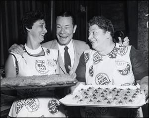 Freda Smith, right, uses a tray of cookies to make Joe E. Brown grin in this 1957 photo.