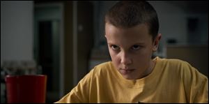 This image released by Netflix shows Millie Bobby Brown in a scene from the first season of 