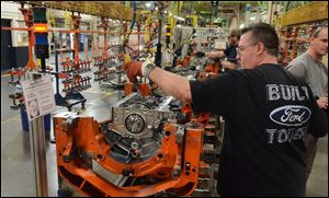 John Wooten places pistons into the new 2.7 Liter Eco-Boost engine for the 2015 F-150 while working on the assembly line at the Lima Ford Engine Plant on Friday, March 28, 2014 in Lima, Ohio.