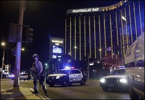 Police officers stand along the Las Vegas Strip near the Mandalay Bay resort and casino during a shooting at a country music festival Oct. 1.