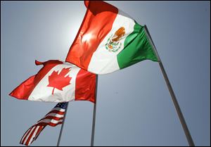 National flags representing the United States, Canada, and Mexico fly in New Orleans where leaders of the North American Free Trade Agreement met in September.