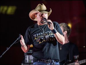 Jason Aldean performs during a surprise pop up concert at the Music City Center in Nashville, Tenn. Aldean returned to his tour Thursday in Tulsa, Oklahoma. The singer was onstage Oct. 1 in Las Vegas when a gunman sprayed bullets into the crowd at the outdoor Route 91 Harvest festival, killing dozens of people and leaving hundreds injured.  