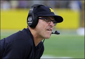 Michigan head coach Jim Harbaugh could only watch as the Wolverines saw some major targets get away on signing day.
