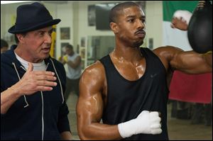This photo provided by Warner Bros. Pictures shows Michael B. Jordan, right, as Adonis Johnson and Sylvester Stallone as Rocky Balboa in 'Creed.'