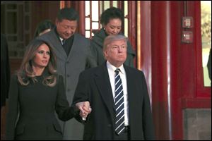 U.S. President Donald Trump and first lady Melania Trump arrive with Chinese President Xi Jinping, left back, and Xi's wife Peng Liyuan, right back, to watch an opera performance at the Forbidden City in Beijing. The White House has called for restrictions in travel and trade to Cuba, which president called for in a June policy speech.