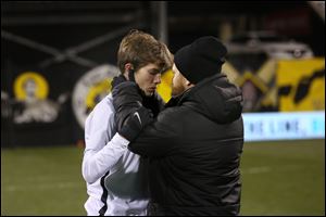 Ottawa Hills' John Kight is comforted by his coach Nate Baer after the Green Bears were defeated 1-0 in the Division III state championship match Saturday in Columbus. 