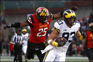 Michigan tight end Zach Gentry rushes past Maryland's Antoine Brooks Jr. for a touchdown in the first half.