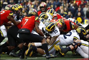 Michigan senior fullback Henry Poggi falls into the end zone for the first touchdown of his collegiate career Saturday against Maryland.