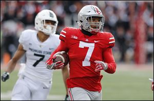Ohio State safety Damon Webb returns an interception against Michigan State Saturday. Even with last weekend's upsets, the Buckeyes are a long shot to make the playoffs.