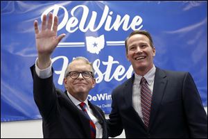 Ohio Attorney General and former U.S. Sen. Mike DeWine, left, and Ohio Secretary of State Jon Husted are piling up a huge campaign war chest.