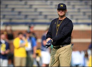 Michigan's Jim Harbaugh looks on before a college football game between the Wolverines and Air Force on September 16. 