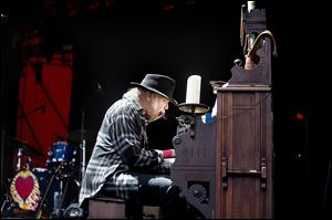 Canadian singer and composer Neil Young performing at the Roskilde Festival in Denmark.