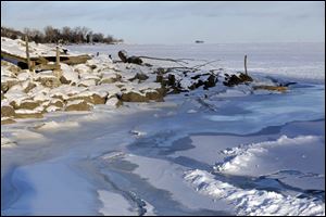 In this file photo, ice cracks and is frozen again along the shoreline of Lake Erie in Point Place.