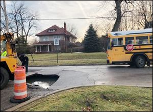 A Grove Patterson Academy Elementary School bus hit a large sinkhole during its morning route Thursday.