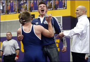 Napoleon's Wesley Jeffries-Babcock, front, celebrates with coaches Austin Ripke, left, and Jason Seiler, right, after defeating Maumee's Ryan Haas in the 182-pound championship during the Northern Lakes League wrestling tournament at Maumee.