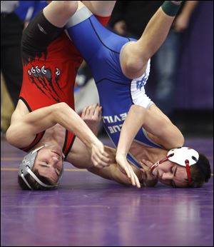 Bowling Green's J.T. Pickens, left, and Springfield's Andrew Stoll wrestle in the 120-pound class at Saturday's Northern Lakes League wrestling championships at Maumee.