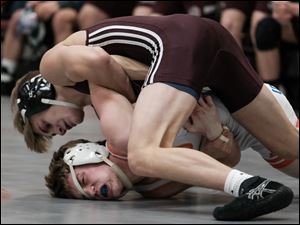 Genoa's Julian Sanchez, top, shown in a dual against Milan Edison this season, was one of nine Comets to win individual titles at Saturday's Northern Buckeye Conference championships.