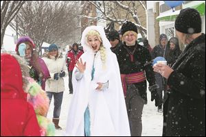 The Winter Queen, played by Laurel Lovitt of Laurel's Princess Party, center, greets children at the Perrysburg Winterfest in 2015.