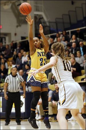 Notre Dame's Jala Johnson shoots over Whitmer's Jenna Thomas during a game earlier this year. She is leading the balanced Eagles in scoring this year at 11.8 points per game.