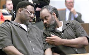 Nathaniel and Anthony Cook whisper during their sentencing at Lucas County Courthouse April 6, 2000.