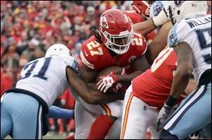 Kansas City Chiefs running back Kareem Hunt carries the ball in a playoff game against the Tennessee Titans this season.