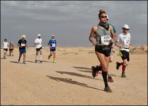 Inma Zanoguera runs in the Sahara Marathon on Monday. In her first career marathon, the former University of Toledo basketball player won the women's race.