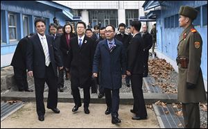 Lee Joo-tae, second from left, director-general for the inter-Korean exchange and cooperation in the South Korean Unification Ministry, crosses to the North side for a meeting to discuss the North's participation in the upcoming Winter Paralympics.