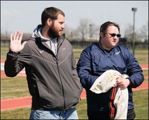 Marcus Vicars, University of Toledo throwing coach, gives instructions to shot put thrower Katie Dewey.