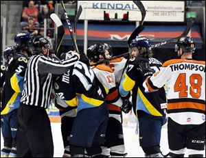 Players from the Walleye and Komets have to be separated by officials during the recently completed Central Division finals won by Fort Wayne.