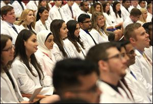 Newly cloaked students listen to Dean of the College of Medicine and Life Sciences Christopher Cooper, M.D., speak during the University of Toledo's White Coat Ceremony at Nitschke Hall Auditorium in 2017.