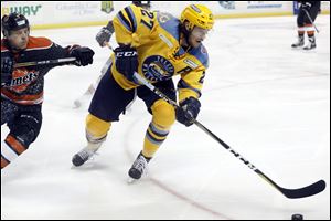 Toledo's A.J. Jenks avoids pressure from Fort Wayne's Jason Binkley during Game 2 of the teams' recently completed playoff series. Jenks has spent four years with the Walleye and is considered an ECHL veteran.